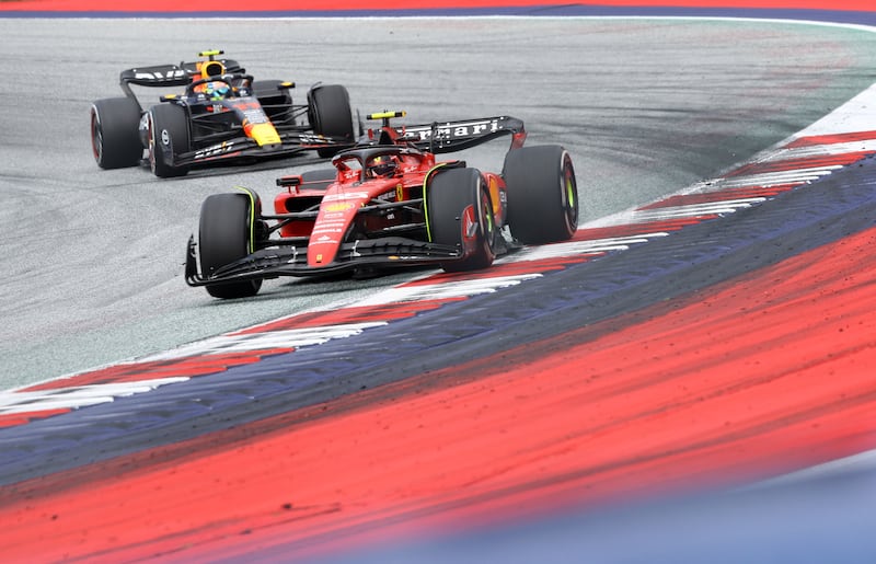 Ferrari's Carlos Sainz ahead Sergio Perez of Red Bull. Reuters
