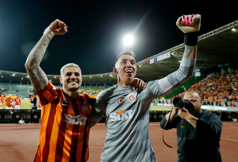 Galatasaray's Mauro Icardi and Fernando Muslera celebrate winning the Turkish Super Cup final. Reuters