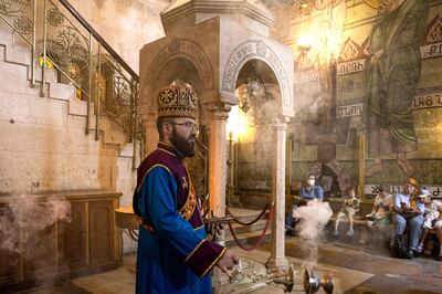 A priest smokes the Church of the Holy Sepulchre with incense in Jerusalem's Old City. AFP