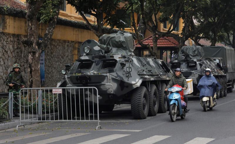 Motorists pass by army vehicles outside the Melia Hotel where North Korea leader Kim Jong-un is expected to stay. AP Photo