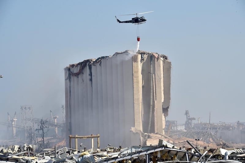 A helicopter trying to put out the fire a day after the explosion rocked Beirut.  EPA