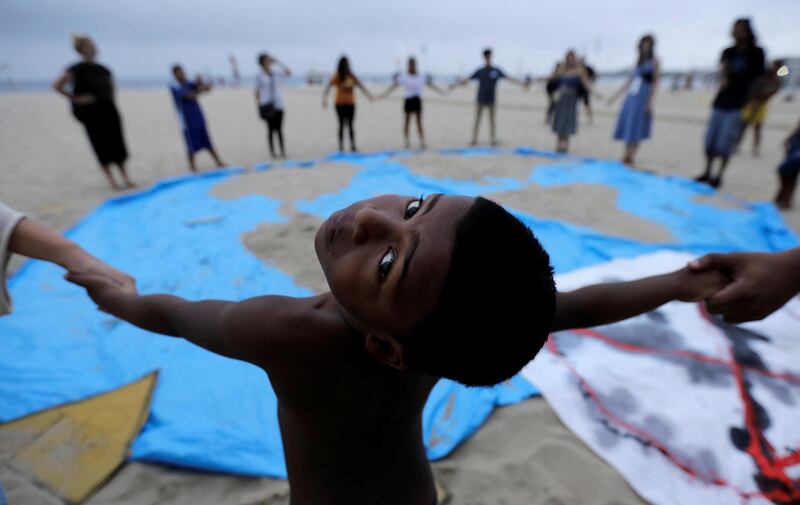 A child and climate change activists attend the Extinction Rebellion protests on Copacabana beach in Rio de Janeiro, Brazil.  Reuters