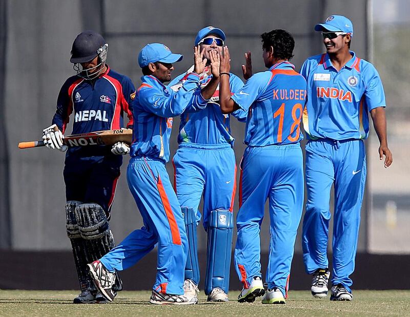 Kuldeep Yadav, of India, celebrates with his teammates after dismissing Nepal’s Raju Rijal during the Under 19 Asia Cup at the ICC Global Academy in Dubai on Sunday. India won by nine wickets to top Group A. Satish Kumar / The National