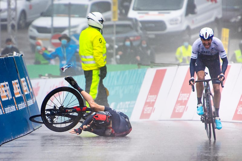 Israel Start-Up Nation rider Michael Woods heads for the finishing line to win Stage 4 of the Tour de Romandie with Geraint Thomas of Ineos Grenadiers on the ground after crashing, on Saturday, May 1. PA