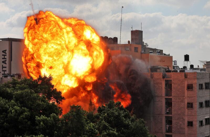 A ball of fire engulfing the Al Walid building which was destroyed in an Israeli airstrike on Gaza city early in the morning on May 13. AFP