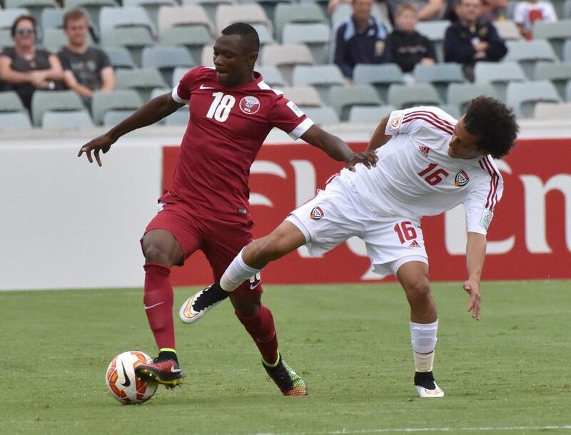 Mohammed Abdullah of Qatar, left, fights for the ball during their Group C Asian Cup football match against the UAE in Canberra. AFP PHOTO / MARK GRAHAM