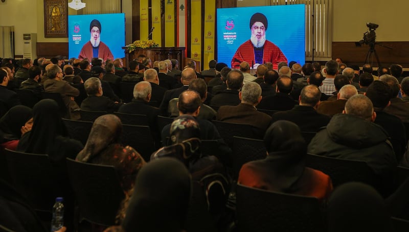 Supporters of Hezbollah listen to Secretary-General Sayeed Hassan Nasrallah as he delivers a speech on a big screen during a rally to mark the 30th anniversary of the establishment of the Islamic Resistance Support Association in Beirut, Lebanon. EPA