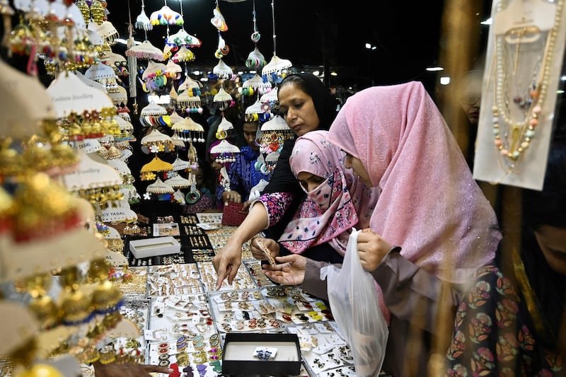Customers select ornaments at a jewellery shop in Karachi. AFP