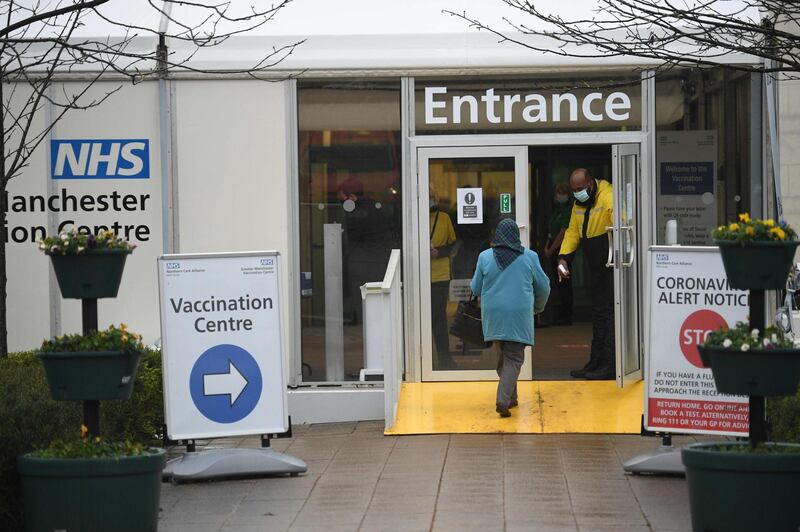 Members of the public arrive at the Etihad tennis centre as it opens as a mass vaccination centre in Manchester. AFP