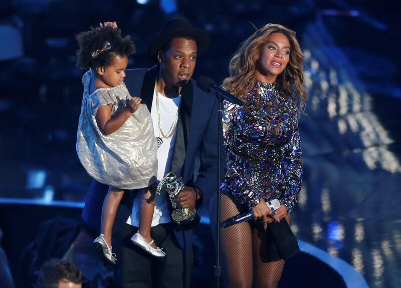 Jay-Z presents the Video Vanguard Award to his wife Beyonce as he holds their daughter Blue Ivy during the 2014 MTV Video Music Awards. Reuters