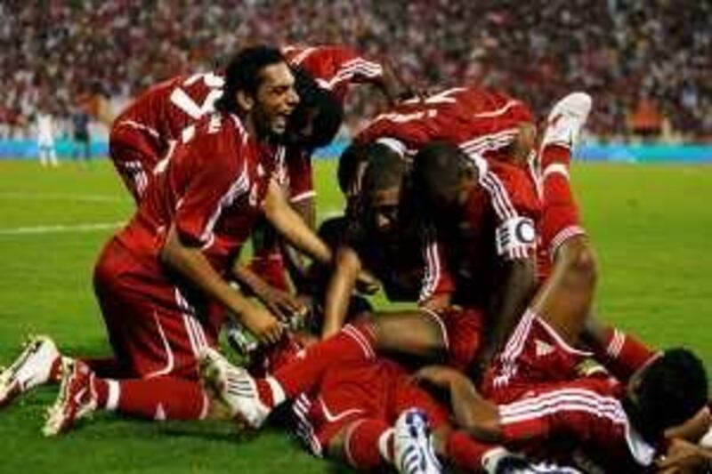 Oman's players celebrate after scoring a goal against Iraq during the 19th Gulf Cup soccer tournament in Muscat January 7, 2009. REUTERS/Fadi Al-Assaad (OMAN) *** Local Caption ***  OMAN17_SOCCER-_0107_11.JPG