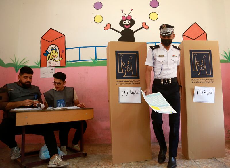 An Iraqi traffic policeman casts his vote at a polling centre in Basra. AP Photo