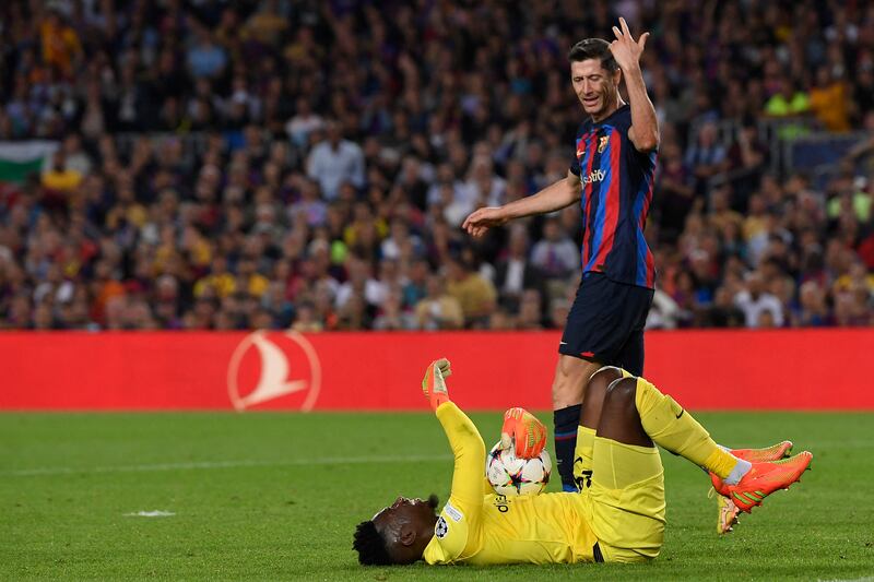 Barcelona forward Robert Lewandowski reacts as Inter Milan goalkeeper Andre Onana lies on the pitch. AFP