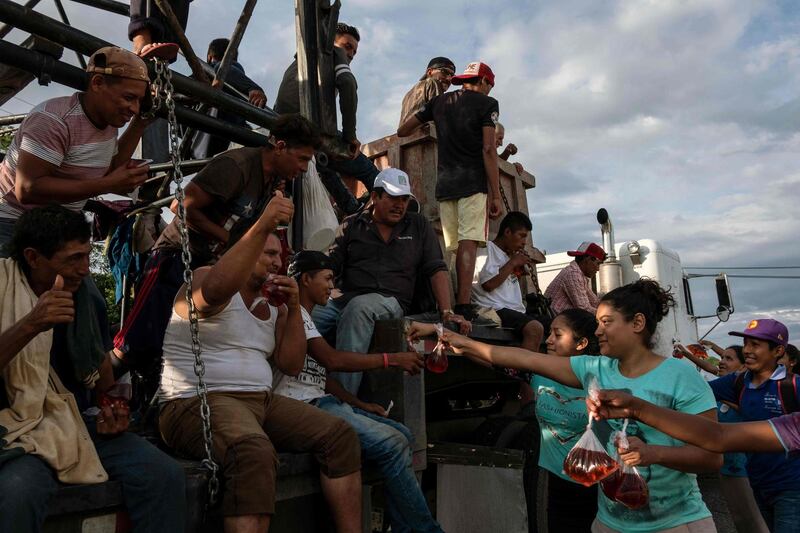 Migrants receive flavoured water from local residents in the Mexican town of Aguilera. AFP