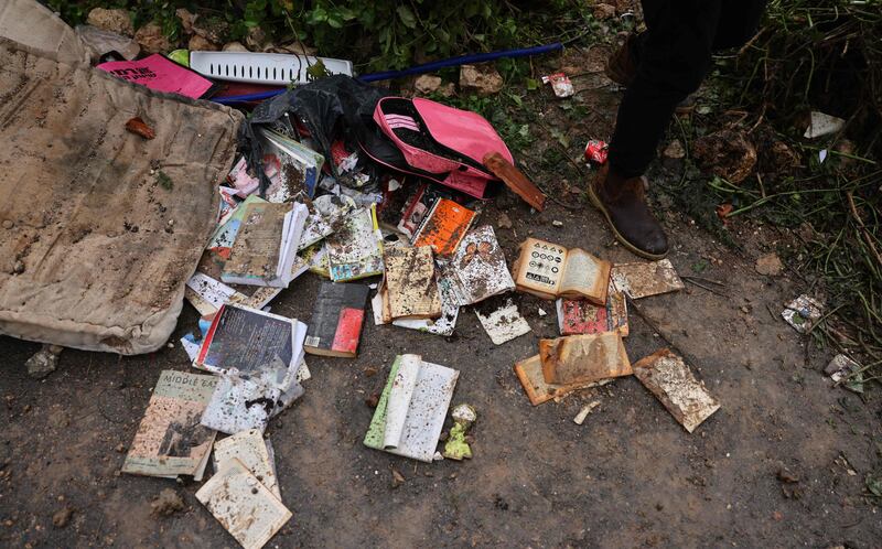 A child's backpack and books lie on the ground by the ruins of the Palestinian house demolished by Israeli forces. AFP