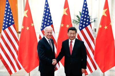 (FILES) In this file photo taken on December 04, 2013 Chinese President Xi Jinping (R) shakes hands with US Vice President Joe Biden (L) inside the Great Hall of the People in Beijing. US President Joe Biden expressed concerns to Chinese leader Xi Jinping about human rights in Hong Kong and Xinjiang late February 10, 2021, in their first call since Biden took office on January 20, according to the White House. / AFP / POOL / LINTAO ZHANG
