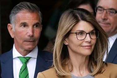 Actress Lori Loughlin, front, and husband, clothing designer Mossimo Giannulli, left, have been sentenced for their roles in a college admissions scandal. AP photo