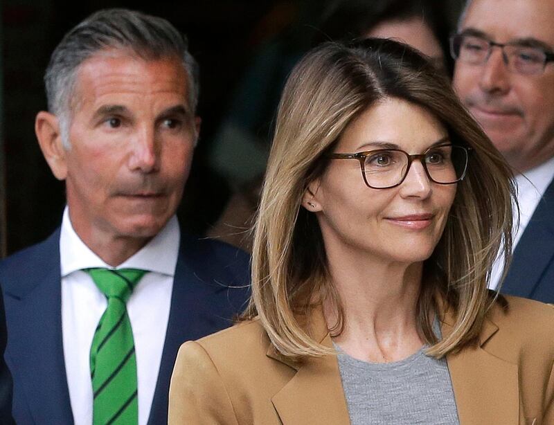 FILE - In this April 3, 2019 file photo, actress Lori Loughlin, front, and husband, clothing designer Mossimo Giannulli, left, depart federal court in Boston after facing charges in a nationwide college admissions bribery scandal. The famous couple pleaded guilty to charges in May 2020, and are scheduled to be sentenced on Friday, Aug. 21, 2020. (AP Photo/Steven Senne, File)