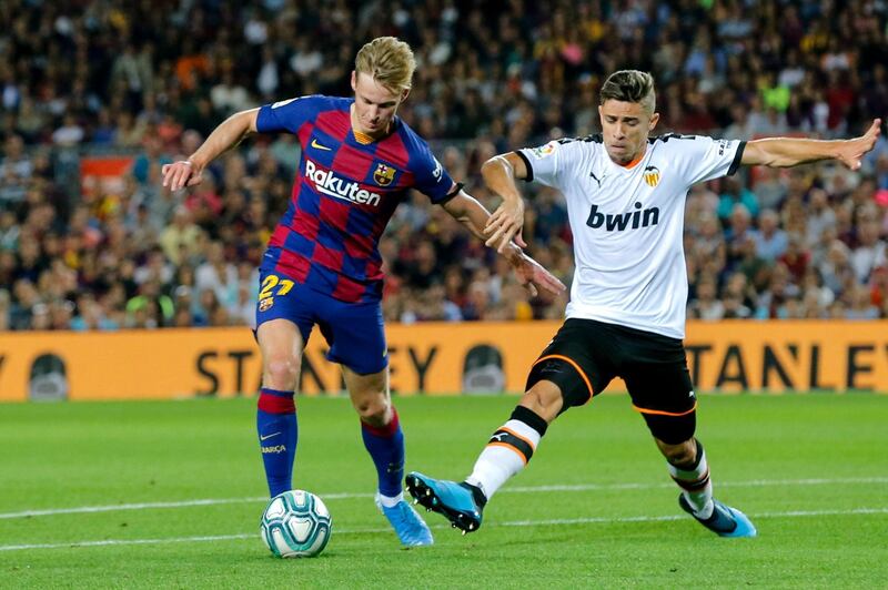 Barcelona's Dutch midfielder Frenkie De Jong vies with Valencia's Brazilian defender Gabriel Paulista. AFP