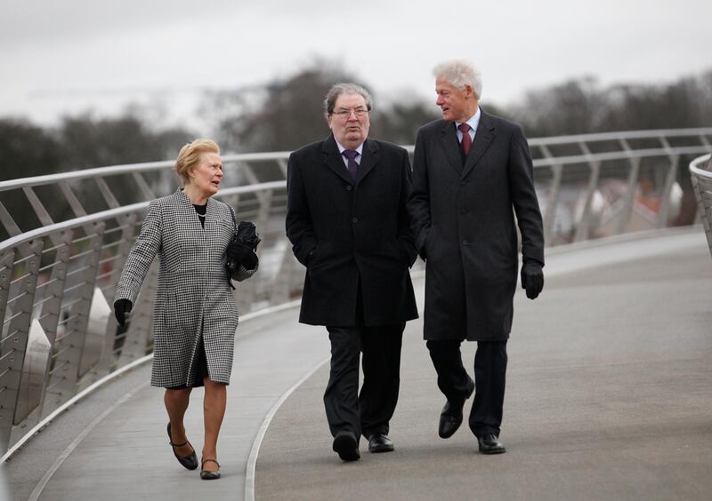 In this March 5, 2014 photo, Bill Clinton, right, walks with John Hume and his wife Pat across the Peace Bridge in Derry, Northern Ireland. AP Photo