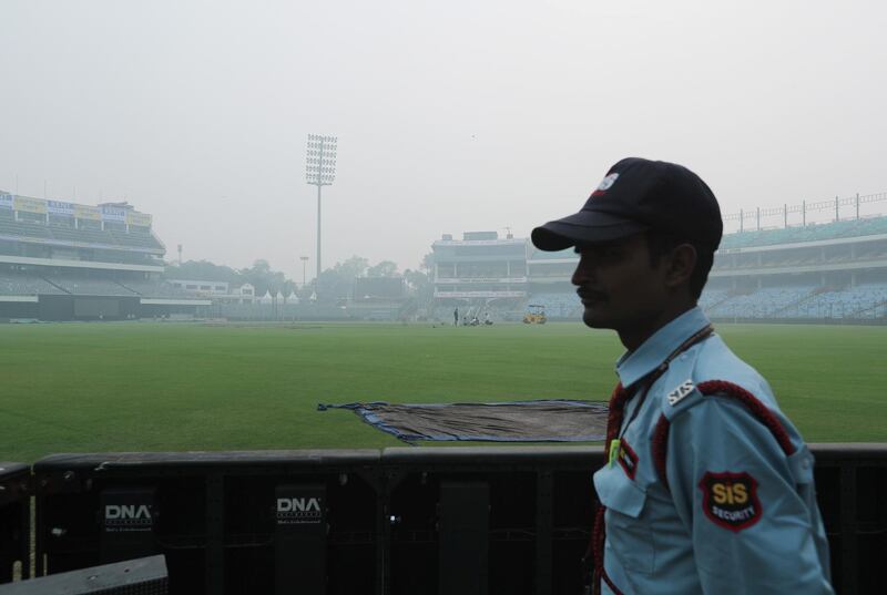 A security guard stands amidst smog during a practice session of Bangladesh ahead of their Twenty20 match against India in New Delhi. Reuters