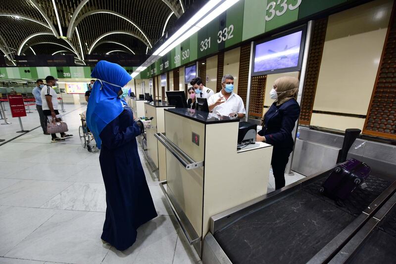 Travellers are served at the check-in desk at Baghdad international Airport in Baghdad.  EPA