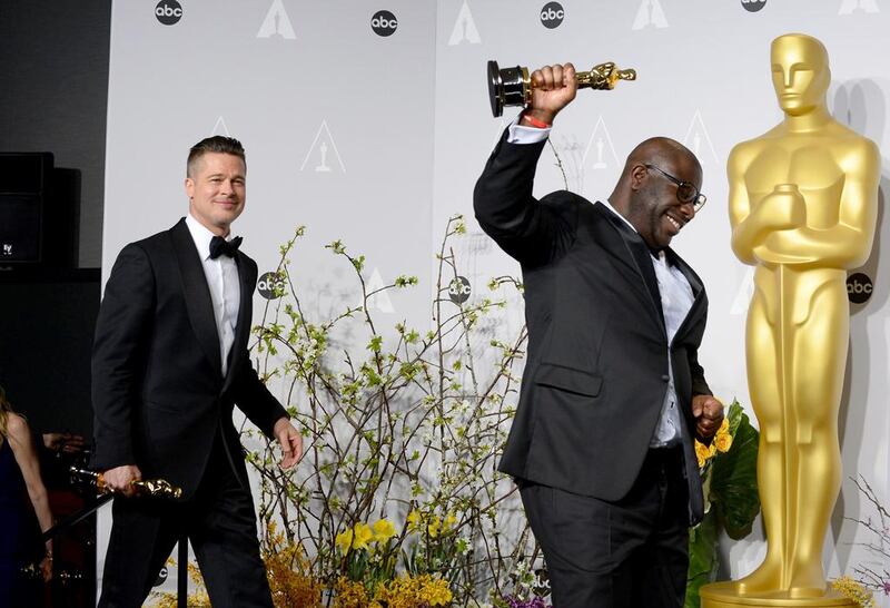 Brad Pitt, left, and Steve McQueen pose in the press room with the award for best picture for 12 Years a Slave. AP 