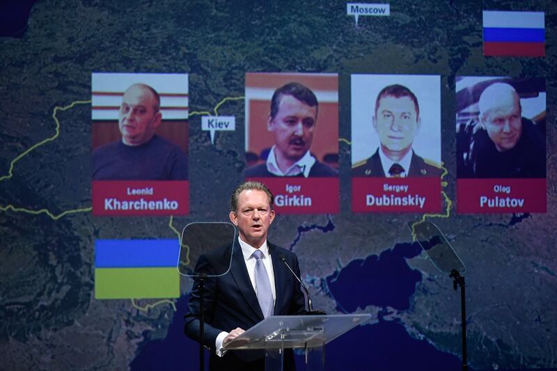 Chief Prosecutor with the National Prosecutor's Office of the Netherlands Fred Westerbeke delivers a speech during a press conference of the Joint Investigation Team on June 19, 2019 in Nieuwegein, on the ongoing investigation of the Malaysia Airlines MH17 crash in 2014, next to the pictures of (from LtoR) Ukrainian Leonid Kharchenko, former FSB colonel Igor Girkin (Strelkov), Sergei Dubinsky employed by Russia's GRU military intelligence agency and former soldier of the Spetznaz GRU Oleg Pulatov. The Dutch-led probe said it was going to prosecute Russian nationals Girkin, Sergei Dubinsky and Oleg Pulatov as well as Ukrainian Leonid Kharchenko, adding they would be placed on national and international wanted lists, over the downing of the Malaysia Airlines plane in July, 2014 when it was shot out of the sky by a BUK missile. / AFP / JOHN THYS
