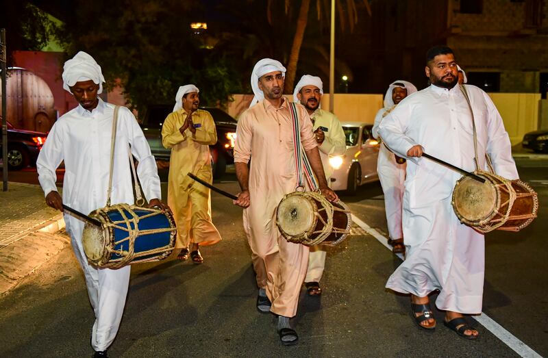 Qatari men play drums and sing traditional songs to awaken people for suhoor in Doha. Getty 