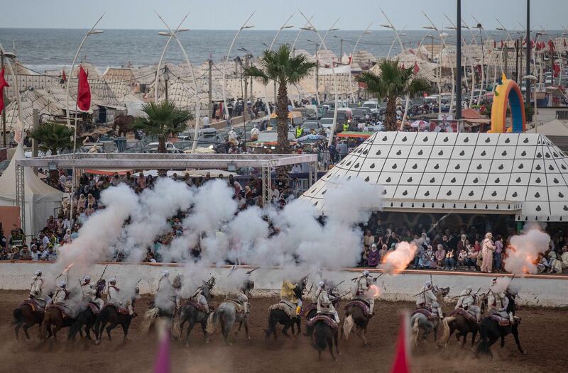 A troupe charges and fires their rifles during Tabourida, a traditional horse riding show also known as Fantasia, in the coastal town of El Jadida, Morocco.