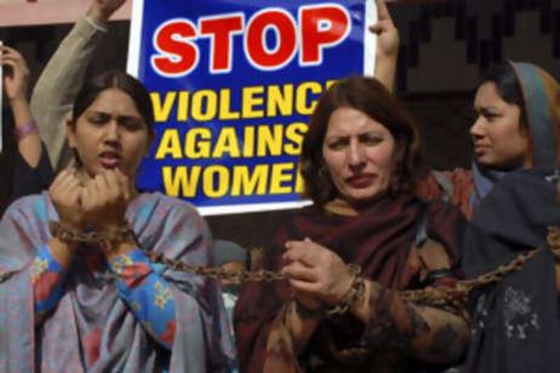 Pakistani women chain themselves during a rally to condemn domestic violence in Multan.