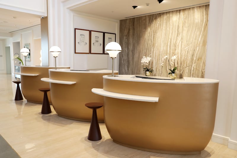 Guests check in at gold-brushed reception desks