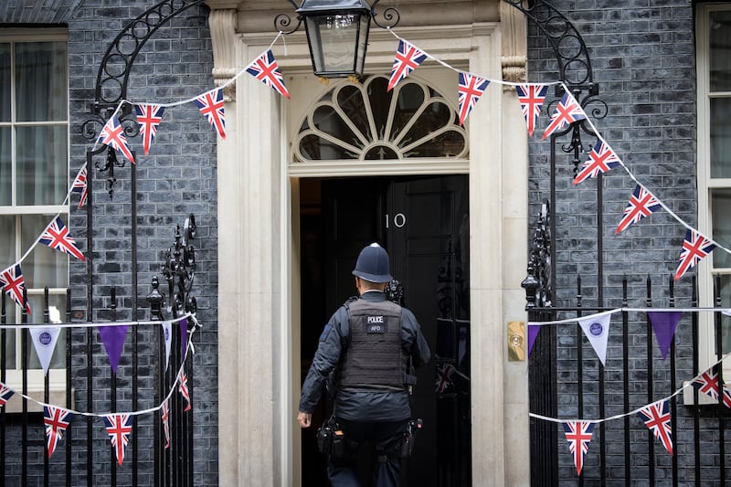 A police officer patrols Downing Street on Monday. The vote of no confidence marked the most serious challenge yet to Mr Johnson's three-year tenure as prime minister. EPA