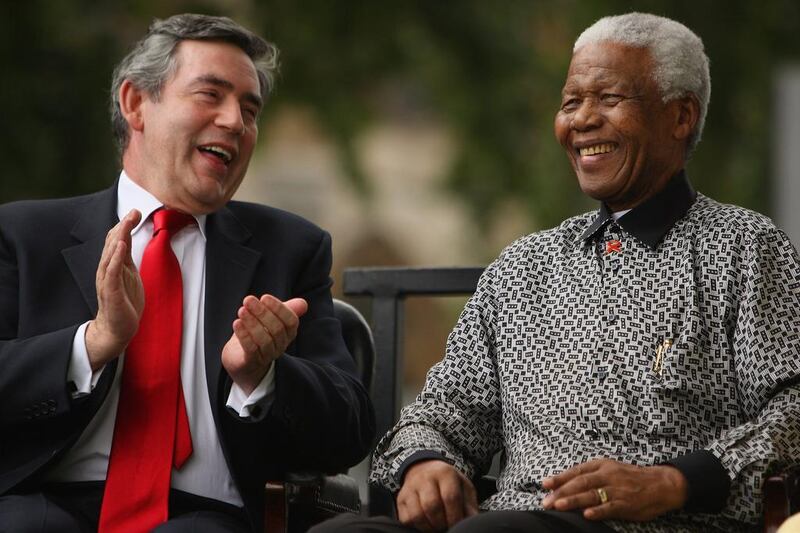 Gordon Brown applauds Mandela during a statue unveiling ceremony in Nelson Mandela’s honour at Parliament Square on August 29, 2007 in London. Daniel Berehulak / Getty Images
