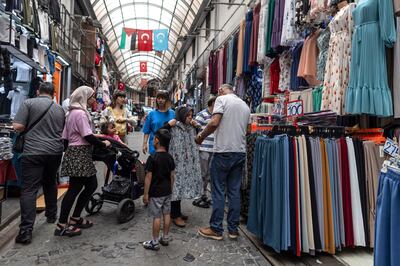 People shop at the Mahmutpasa bazaar in Istanbul, Turkey. The central bank now expects inflation to end this year at 58 per cent, up from an earlier forecast of 22.3 per cent. EPA
