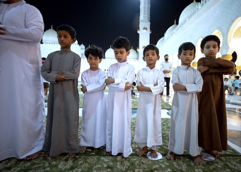 Young Emiratis in national dress come to pray.