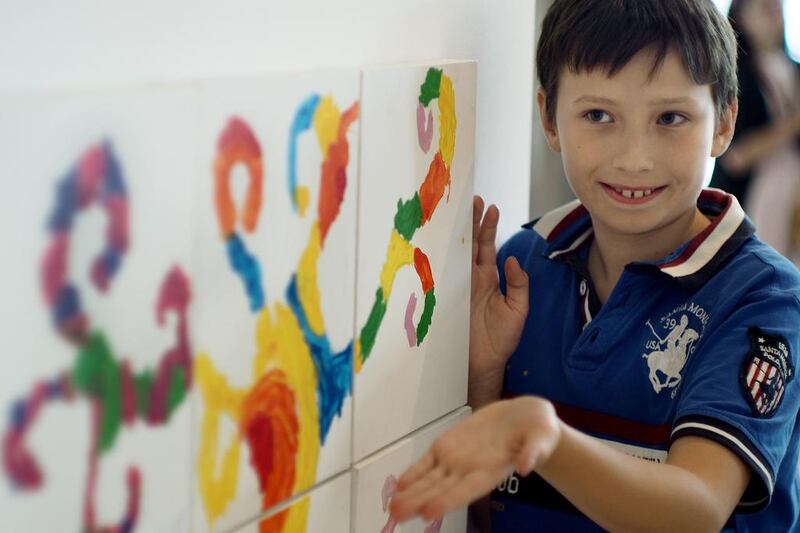 Young artist Thanderbee Vislykh was only too happy to show off works he and other children had hanging at The Galleria Mall on Al Maryah Island on Tuesday. Delores Johnson / The National