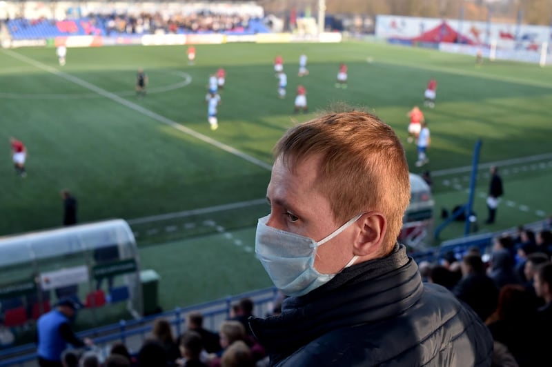 A supporter of FC Minsk, wears a facemask for protection. AFP