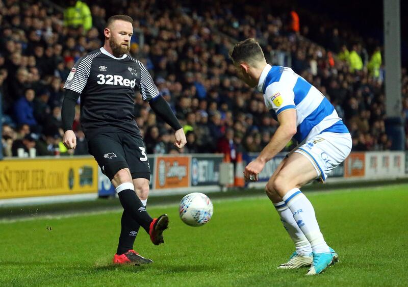 Wayne Rooney chips the ball past Queens Park Rangers' Marc Pugh during the Championship match at Loftus Road on February 25. PA