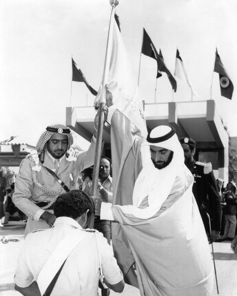 Sheikh Zayed and Sheikh Khalifa bin Zayed raise a flag at the graduation ceremony of the first batch of officers of the Zayed Military Academy in Al Ain on April 10, 1973.