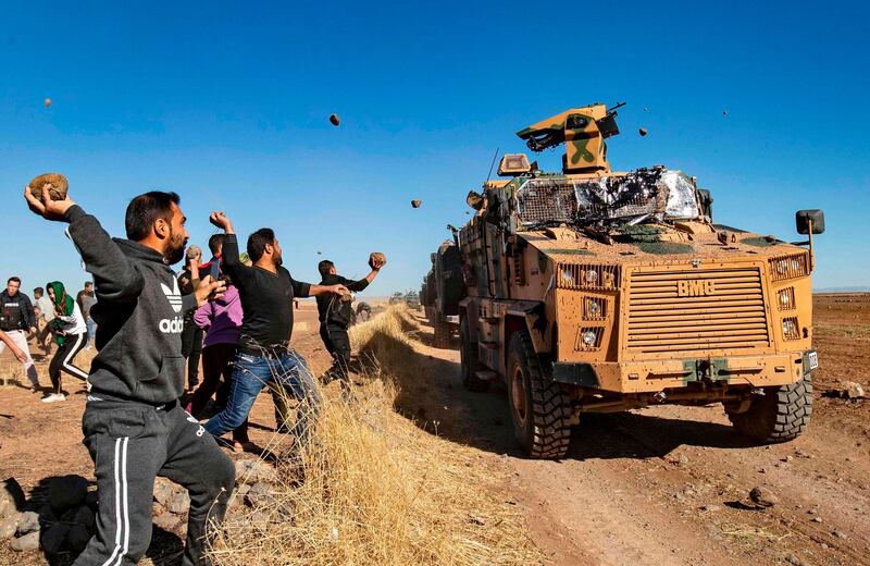 - AFP PICTURES OF THE YEAR 2019 - 

Kurdish demonstrators hurl rocks at a Turkish military vehicle on November 8, 2019, during a joint Turkish-Russian patrol near the town of Al-Muabbadah in the northeastern part of Hassakah on the Syrian border with Turkey. / AFP / Delil SOULEIMAN
