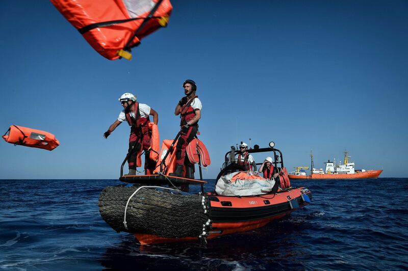 Members of humanitarian organisations SOS Mediterranee and Medecins Sans Frontieres (MSF - Doctors Without Borders) perform a rescue drill during a joint operation at the MV Aquarius, a search and rescue ship run in partnership between the SOS Mediterranee and MSF, some 24 nautical miles (50km) off Libya's coast, in the Mediterranean Sea. Louisa Gouliamaki / AFP