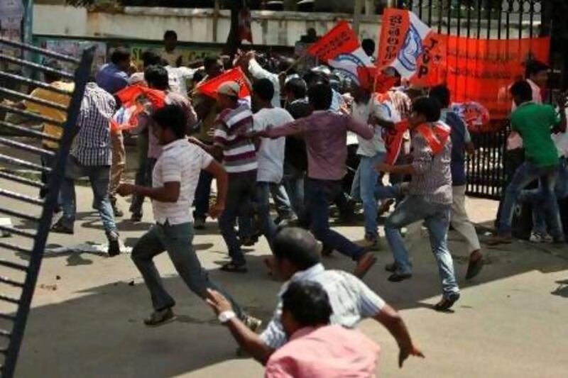 Indian students pelt stones at police during a protest demanding the creation of a new state named ‘Telangana’ in Hyderabad, India.