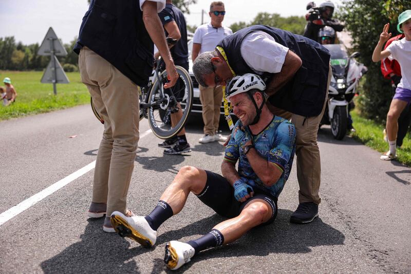 Astana Qazaqstan Team's British rider Mark Cavendish receives medical attention after suffering a crash during the eighth stage of the Tour de France on Saturday, July 8, 2023. AFP
