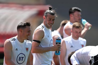 epa09257002 Gareth Bale (2-L) and the national team players of Wales warm up during a training session at Tofiq Bahramov Stadium before the UEFA EURO 2020 soccer tournament in Baku, Azerbaijan, 09 June 2021. The UEFA EURO 2020 soccer tournament will be held from 11 June to 11 July 2021 with four matches in Baku. EPA/TOLGA BOZOGLU