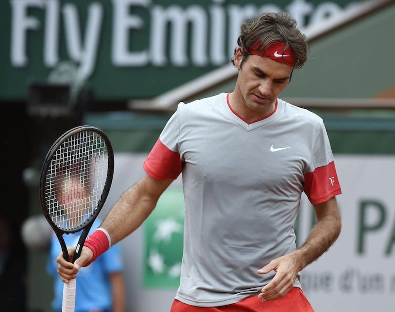 Roger Federer reacts during his loss to Ernests Gulbis at the French Open on Sunday. Pascal Guyot / AFP / June 1, 2014