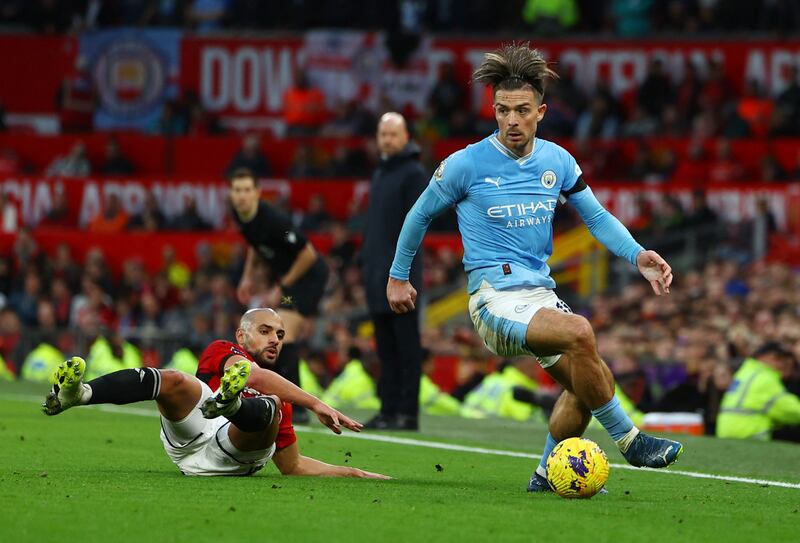 Manchester United's Sofyan Amrabat, left, duels with Manchester City's Jack Grealish. Reuters 