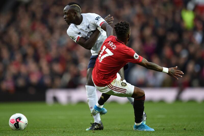 Liverpool's Senegalese striker Sadio Mane (L) vies with Manchester United's Brazilian midfielder Fred (R) during the English Premier League football match between Manchester United and Liverpool at Old Trafford in Manchester, north west England, on October 20, 2019. RESTRICTED TO EDITORIAL USE. No use with unauthorized audio, video, data, fixture lists, club/league logos or 'live' services. Online in-match use limited to 120 images. An additional 40 images may be used in extra time. No video emulation. Social media in-match use limited to 120 images. An additional 40 images may be used in extra time. No use in betting publications, games or single club/league/player publications.
 / AFP / Oli SCARFF                           / RESTRICTED TO EDITORIAL USE. No use with unauthorized audio, video, data, fixture lists, club/league logos or 'live' services. Online in-match use limited to 120 images. An additional 40 images may be used in extra time. No video emulation. Social media in-match use limited to 120 images. An additional 40 images may be used in extra time. No use in betting publications, games or single club/league/player publications.
