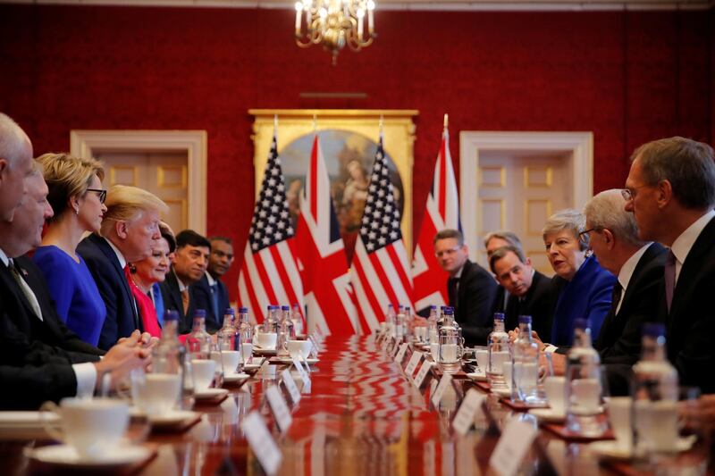 US President Donald Trump and Britain's Prime Minister Theresa May attend a business round-table discussion at St James's Palace during his state visit in London, Britain. Reuters