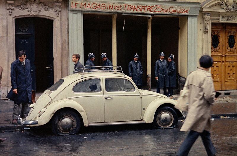 Parisian police officers stand in front of a damaged Beetle on a street in the Latin Quarter of Paris. AP Photo
